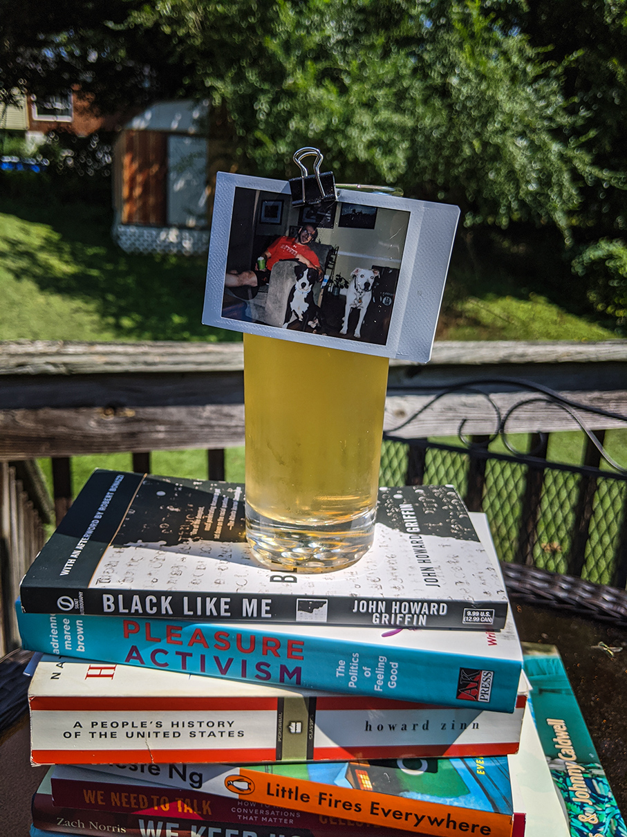Photo clipped to drink on stack of books