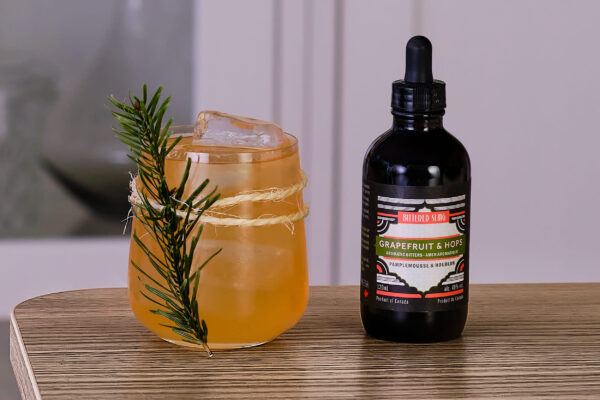 Drink with Grapefruit and Hops bitters beside it